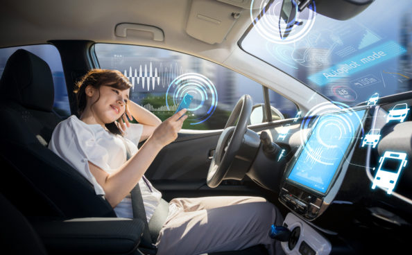A woman driving in a autonomous driving car